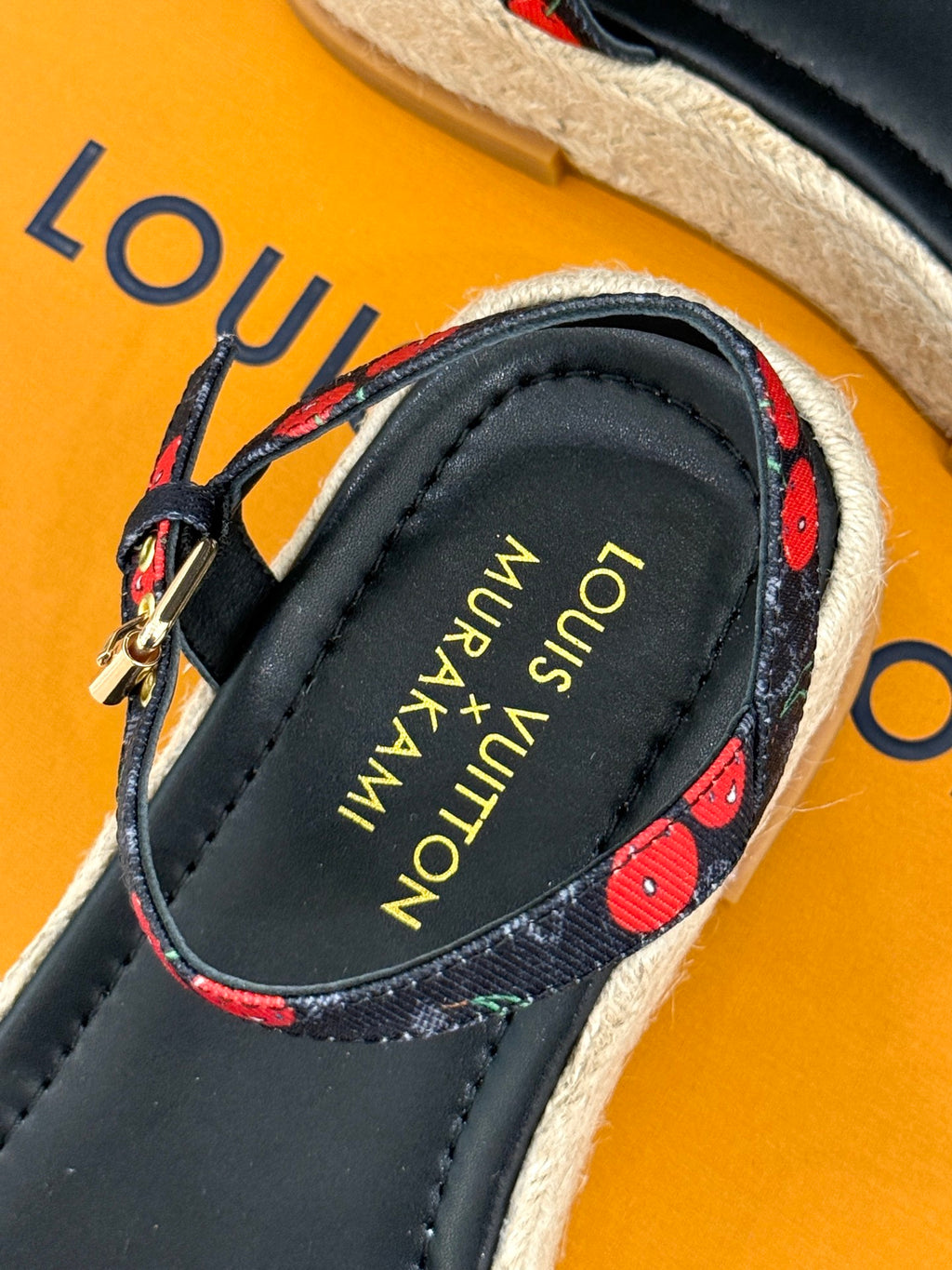 Louis Vuitton black espadrille sandal with cherry-pattern straps and brand logo insole.