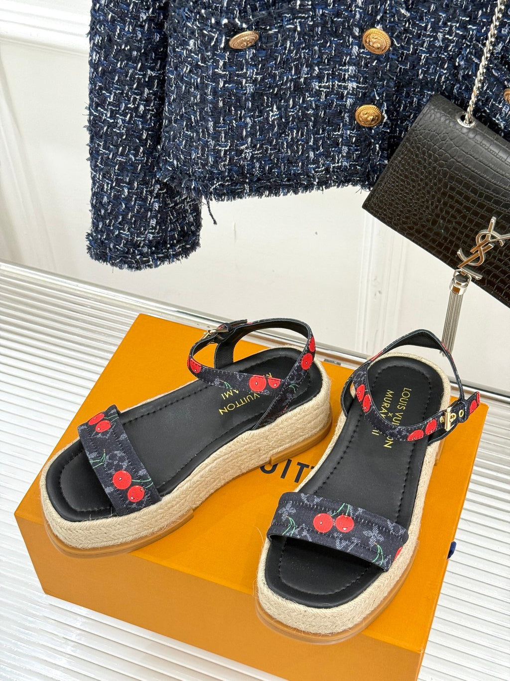 Louis Vuitton black espadrille slide sandals with cherry-print straps on woven midsoles.