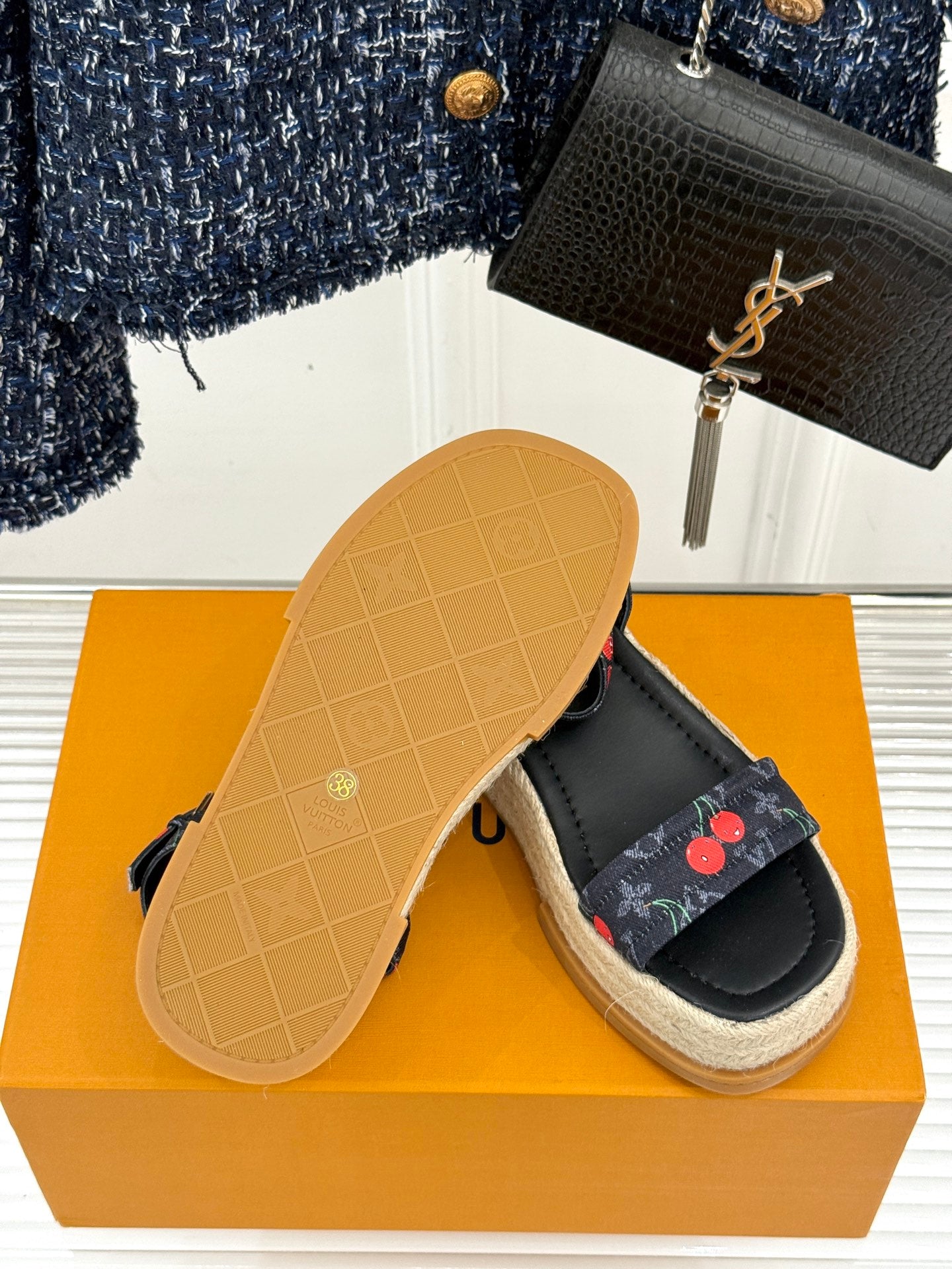 Louis Vuitton black platform espadrille sandals with cherry-pattern straps and tan rubber outsole.