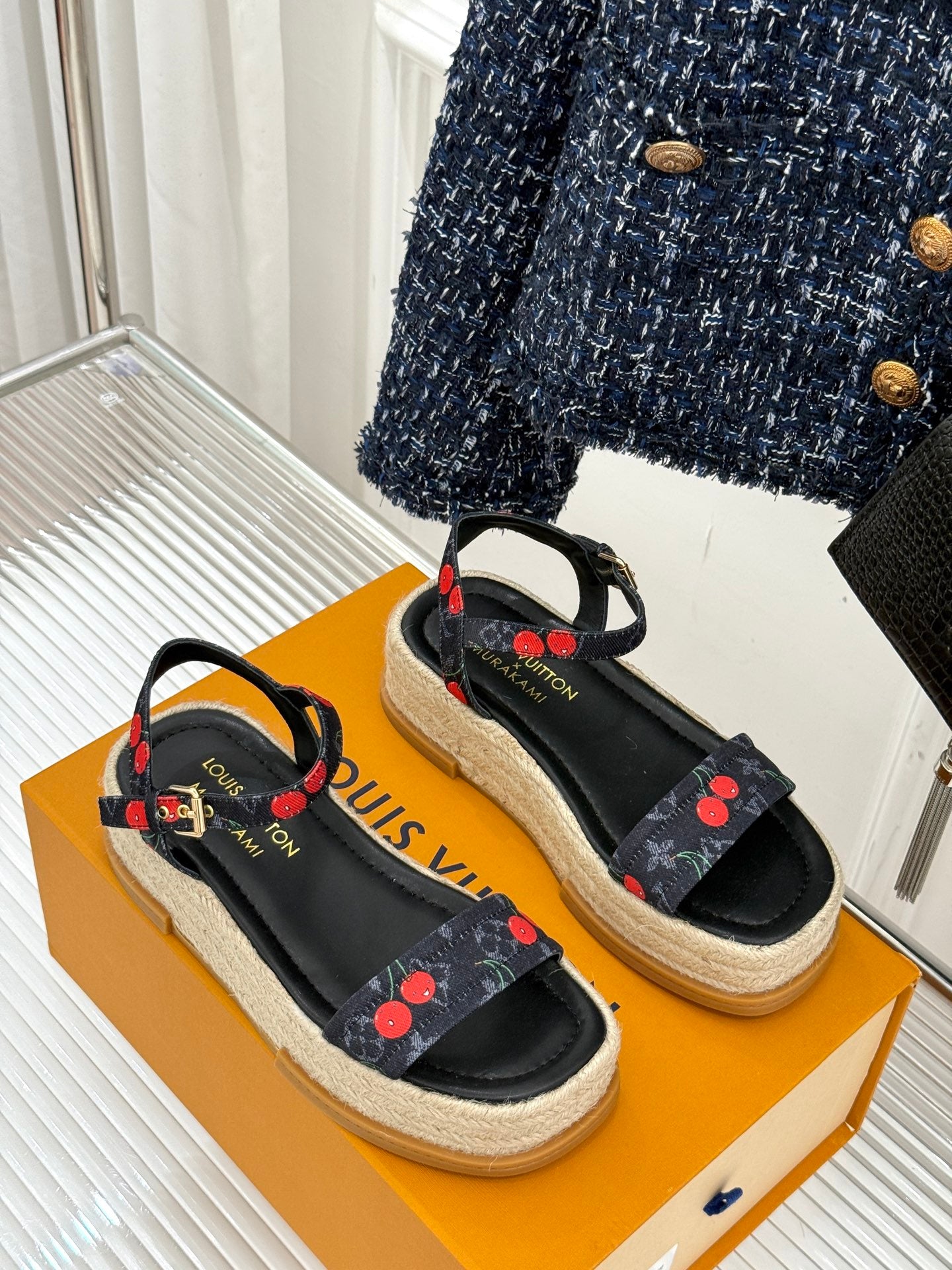Louis Vuitton black platform espadrille sandals with cherry-pattern ribbon straps and open toe.