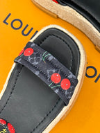 Louis Vuitton black espadrille slide with cherry-pattern strap trim and stitched leather upper.