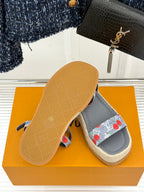 Grey espadrille sandals with cherry-print straps showing textured outsole