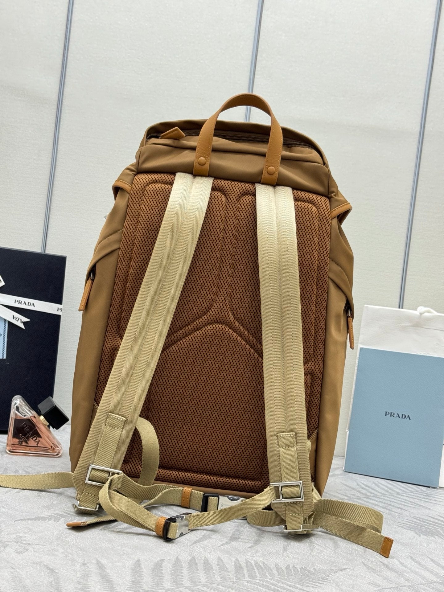 Prada tan backpack back view with padded mesh panel and adjustable shoulder straps