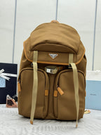 Prada tan backpack with top handle, drawstring hood, and front storage pockets