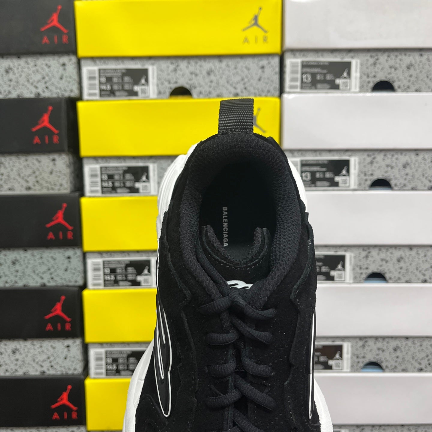 Black suede lace-up sneaker heel and collar, white outsole edge