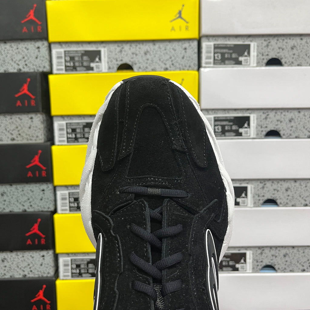 Black lace-up sneaker tongue and eyelets, suede upper