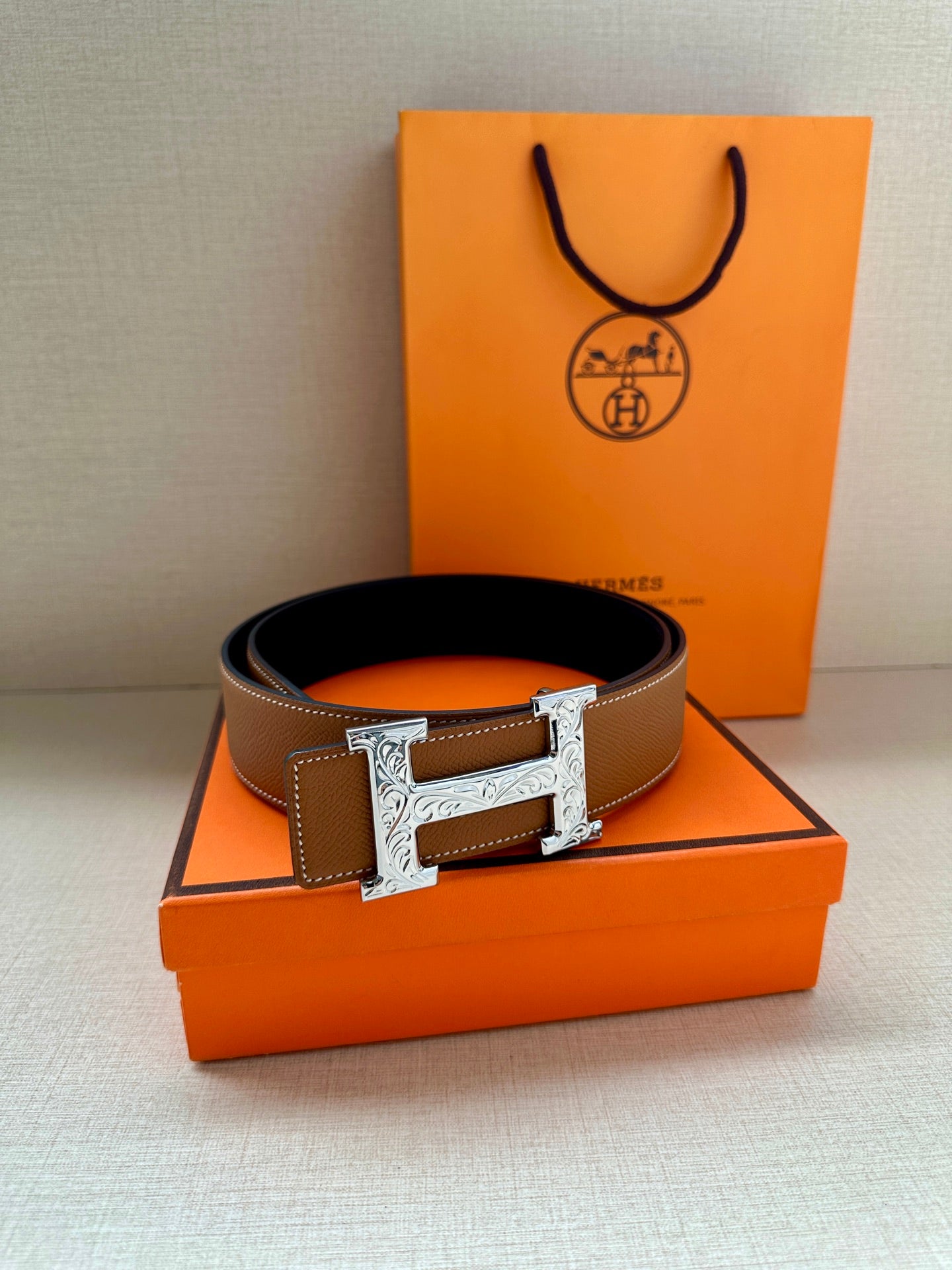 Hermes leather belt with silver H buckle on tan-brown strap, with box