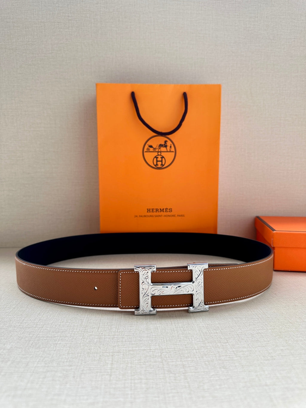 Hermes leather belt with silver H buckle and tan-brown strap