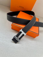 Dark navy leather belt with silver-tone buckle and keeper strap detail.