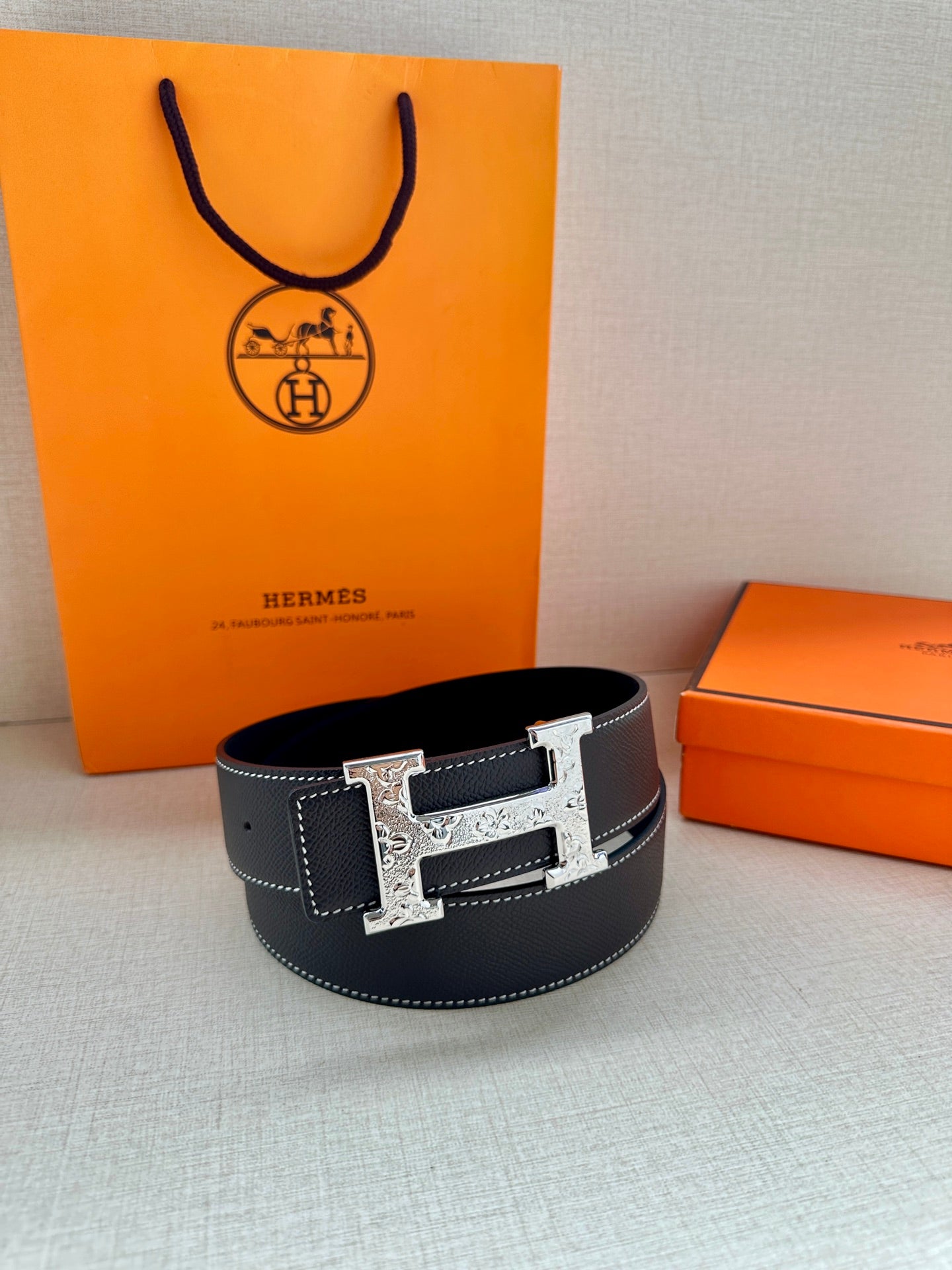 Dark navy leather belt with silver-tone buckle, shown with full width and ends.