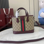 Gucci handbag with GG canvas front, burgundy base, green/red stripe, single shoulder strap.