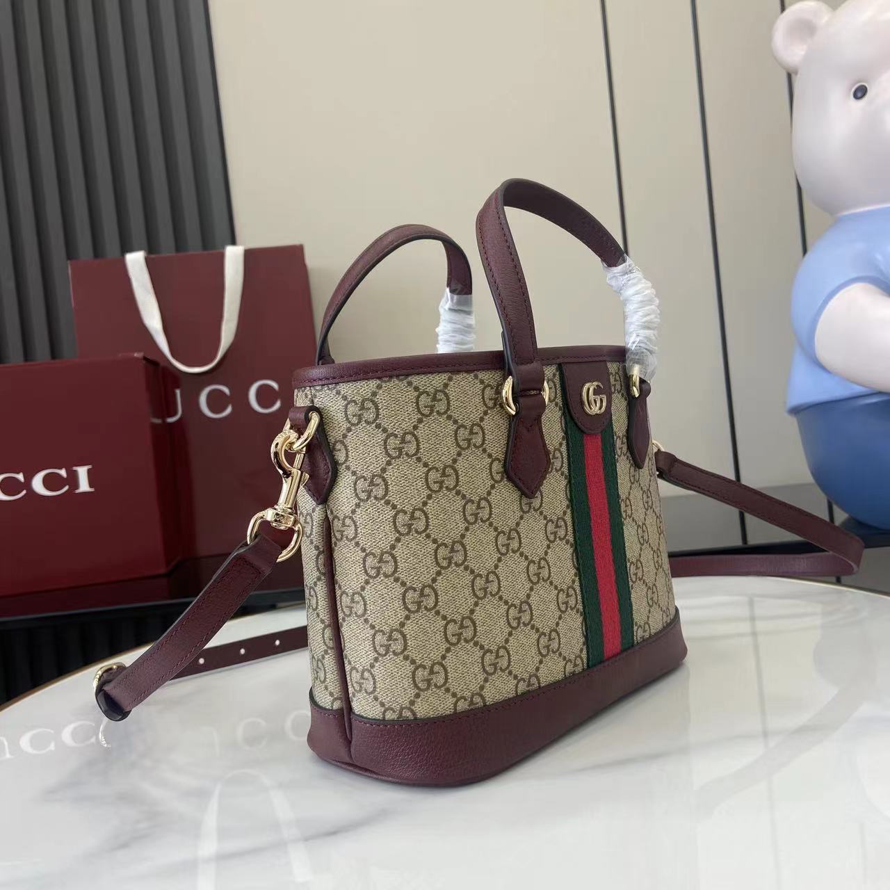 Gucci handbag in GG canvas with burgundy leather edges, web stripe detail, shoulder strap.
