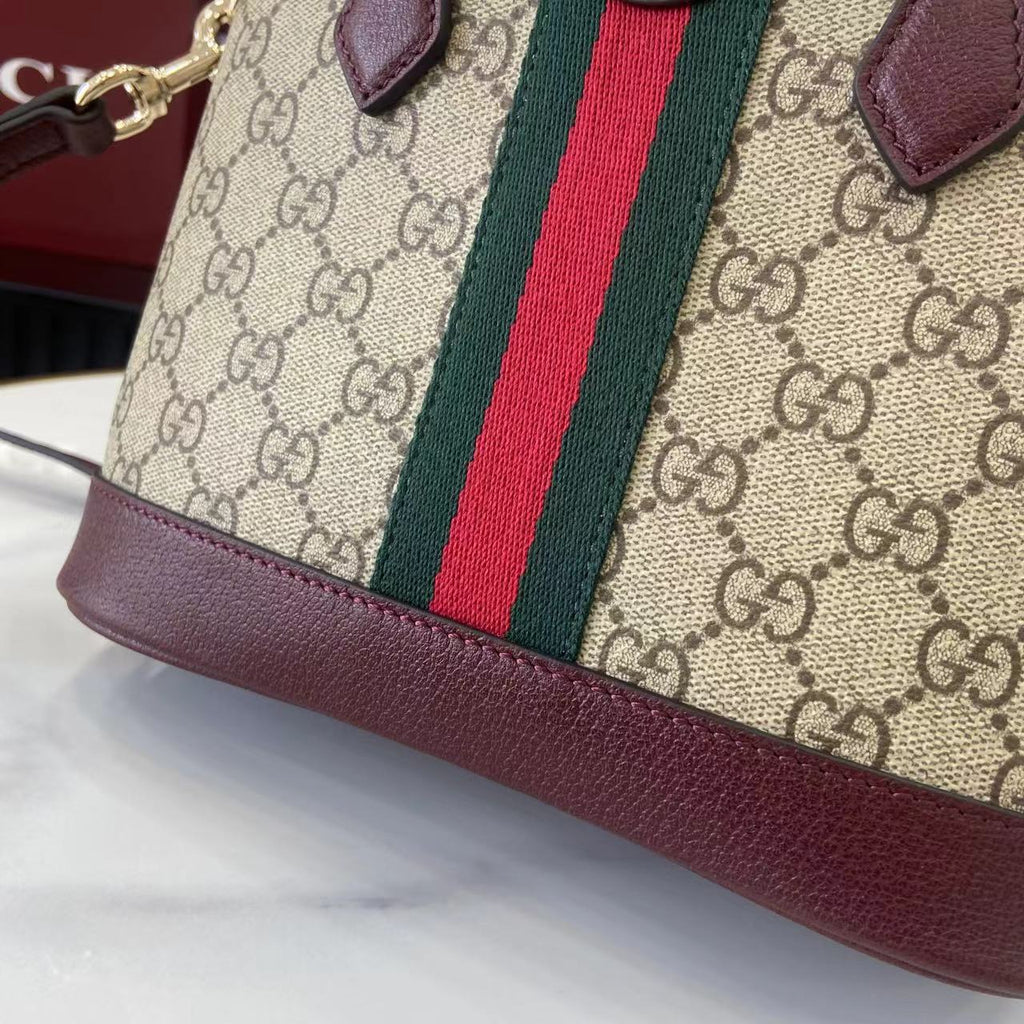 Gucci bag corner with GG canvas, green and red stripe, burgundy leather bottom trim.