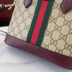 Gucci bag corner with GG canvas, green and red stripe, burgundy leather bottom trim.