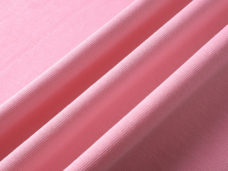 Pink knit T-shirt fabric texture with folded seam detail