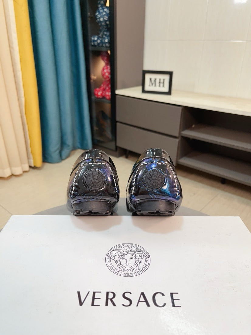 Shiny dark blue loafer pair with rounded toe and sleek vamp stitching