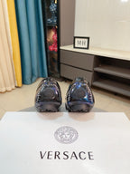 Shiny dark blue loafer pair with rounded toe and sleek vamp stitching