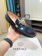 Dark blue patterned loafer with gold lion emblem and blue floral print