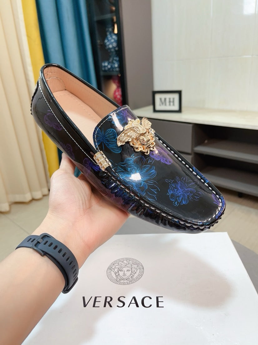 Dark blue patterned loafer with gold lion emblem and blue floral print