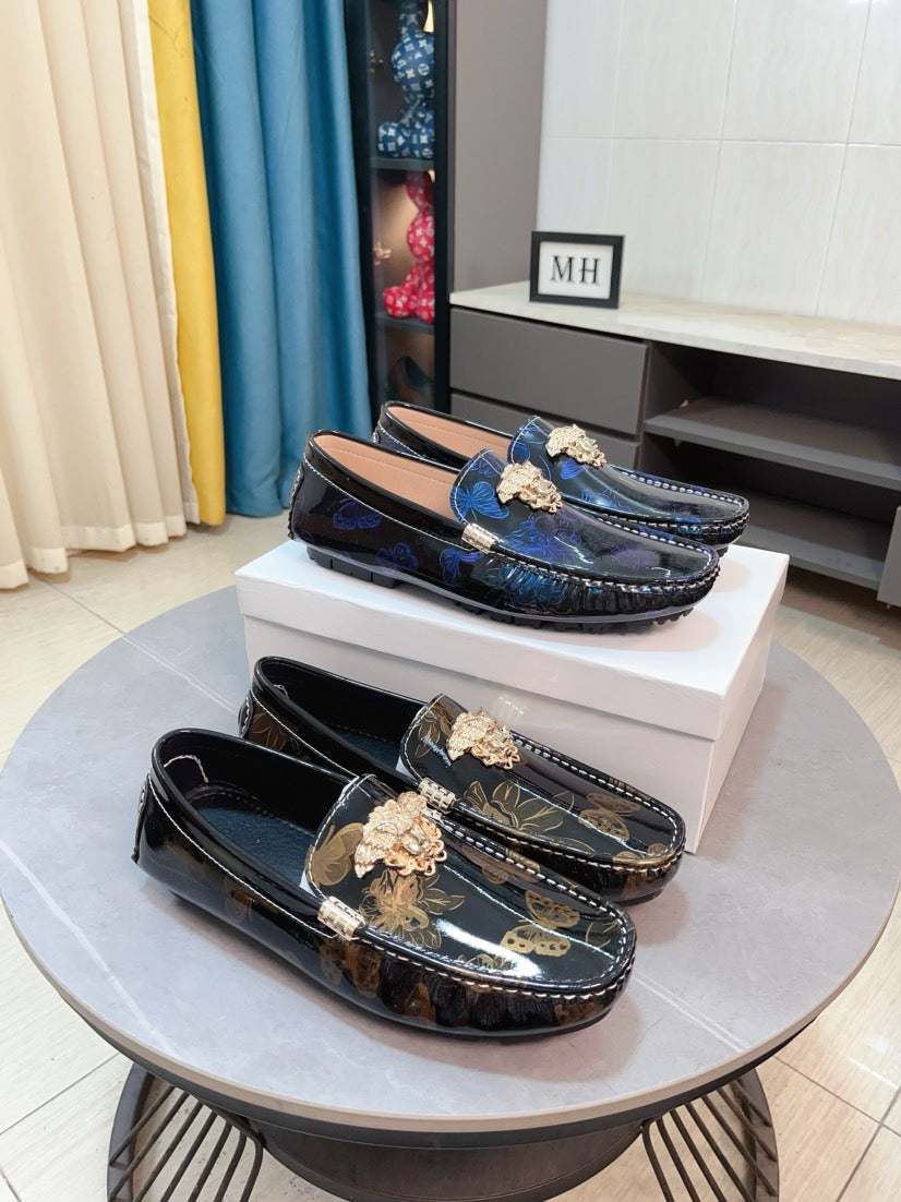 Dark blue patterned loafers with gold lion clasp and decorative buckle detail