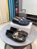 Dark blue patterned loafers with gold lion clasp and decorative buckle detail