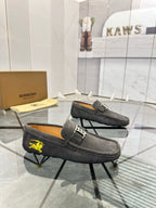 Dark gray suede loafers with B logo buckle strap and yellow horse emblem