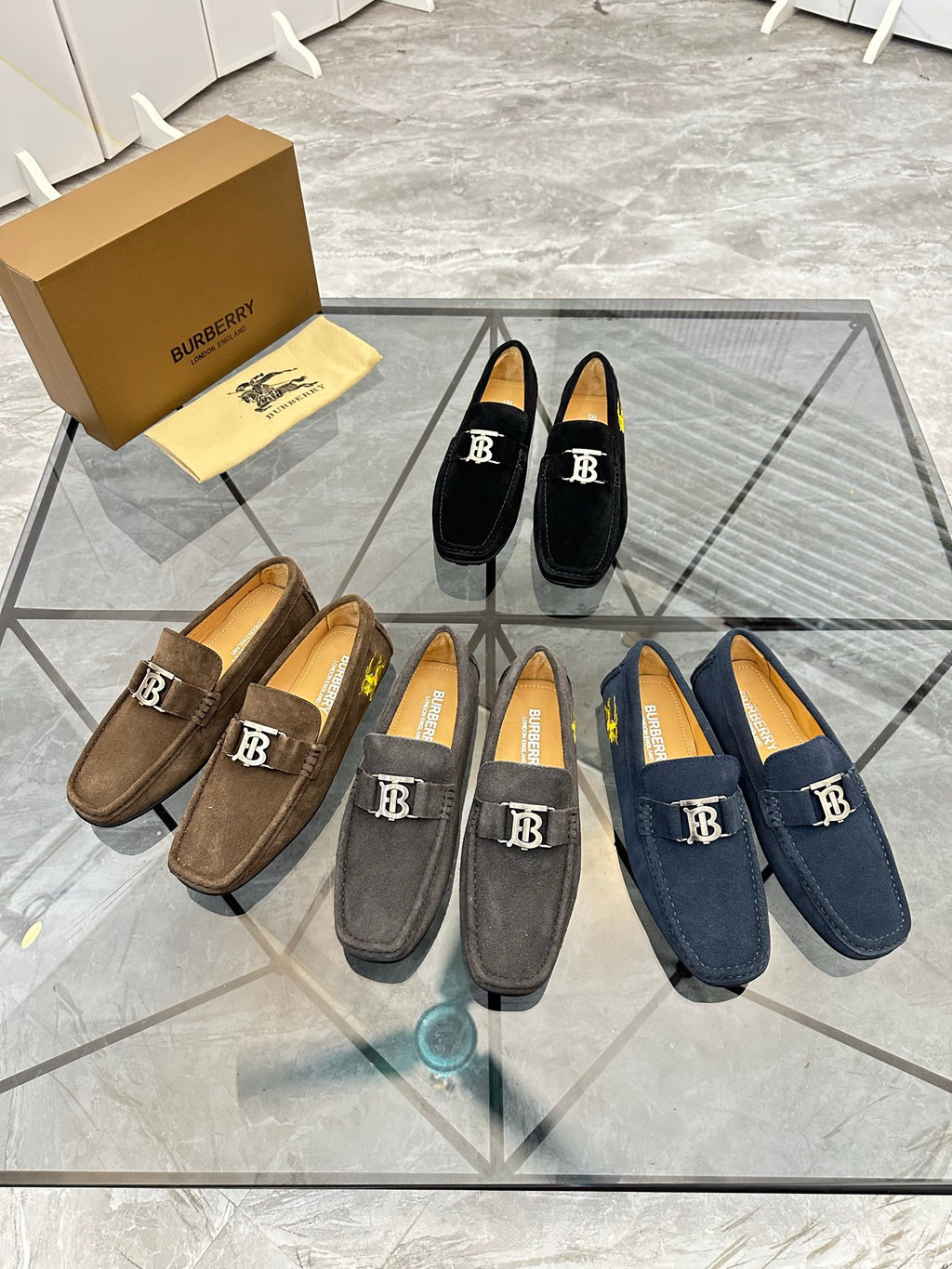 Assorted suede loafers in brown, gray, and navy with B logo straps