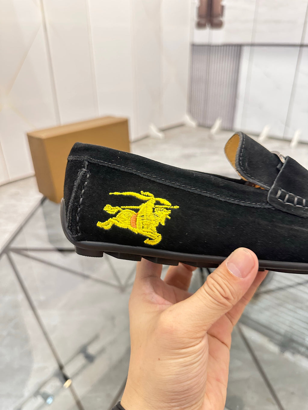 Burberry black loafer detail with yellow horse logo on the side