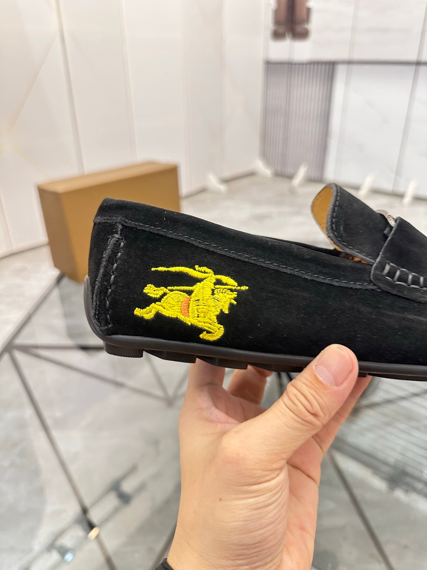 Burberry black loafer detail with yellow horse logo on the side