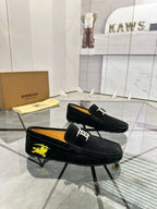 Burberry black loafer with yellow horse emblem and gold-tone front buckle