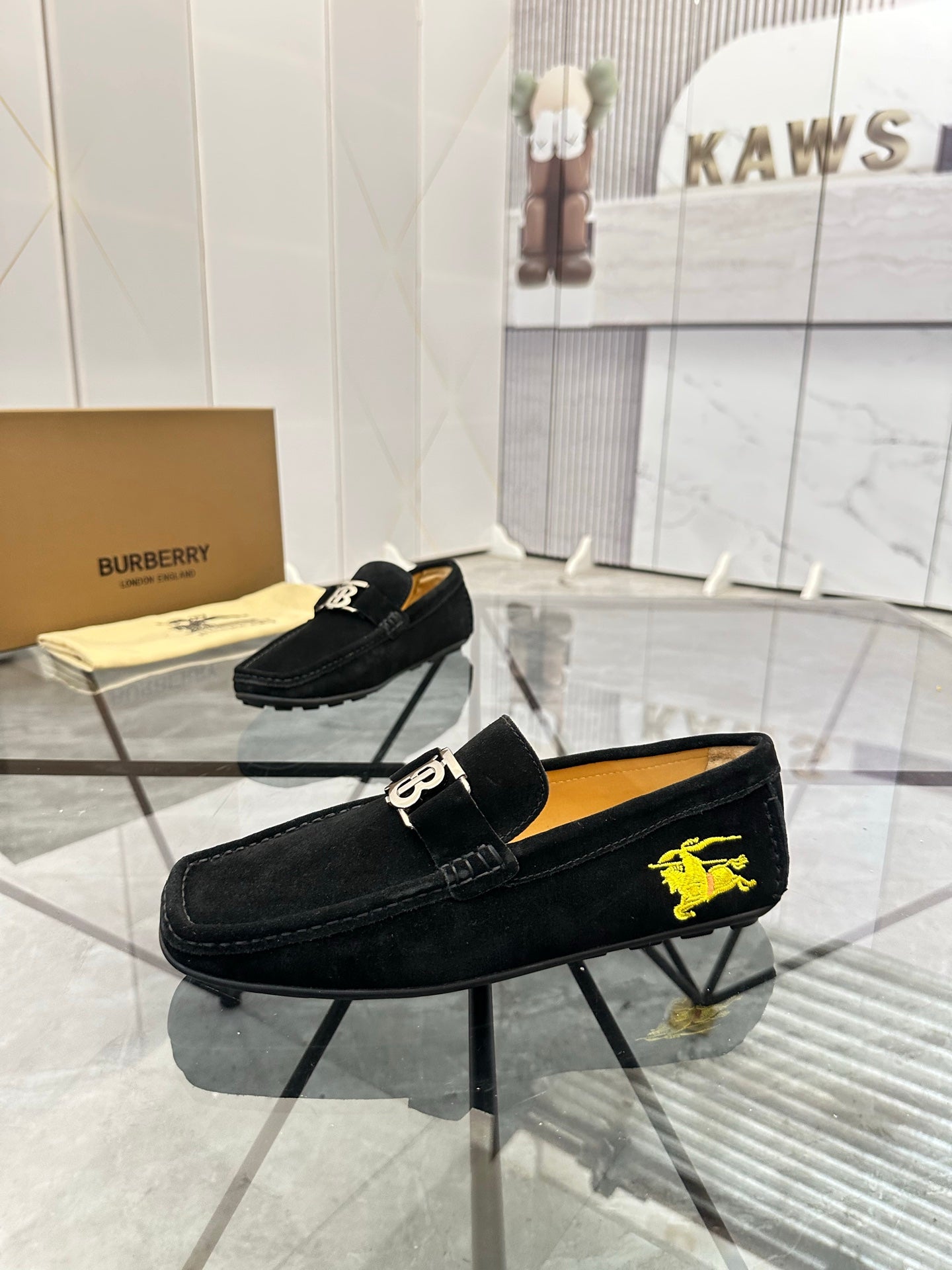 Burberry black loafer with yellow horse emblem and gold-tone buckle detail