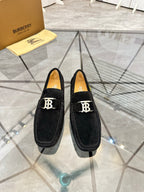 Burberry black loafers with square “B” buckle on the front, pair view