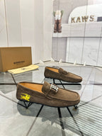 Brown suede loafer with slip-on top, yellow horse emblem, and B logo detail.