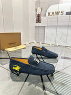 Navy suede loafer with yellow horse emblem and gold-tone B buckle