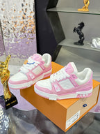 Pink and white Louis Vuitton sneakers on orange box, front and side views