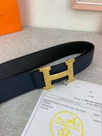 Hermes belt close-up: dark blue leather with gold-tone buckle and keeper