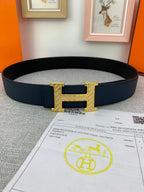 Hermes belt in dark blue with gold-tone H buckle and keeper, laid on receipt