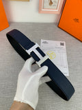 Hermes belt in dark blue with silver-tone buckle and keeper, shown folded on glove