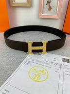 Hermes belt with dark leather strap and gold H buckle, shown with receipt
