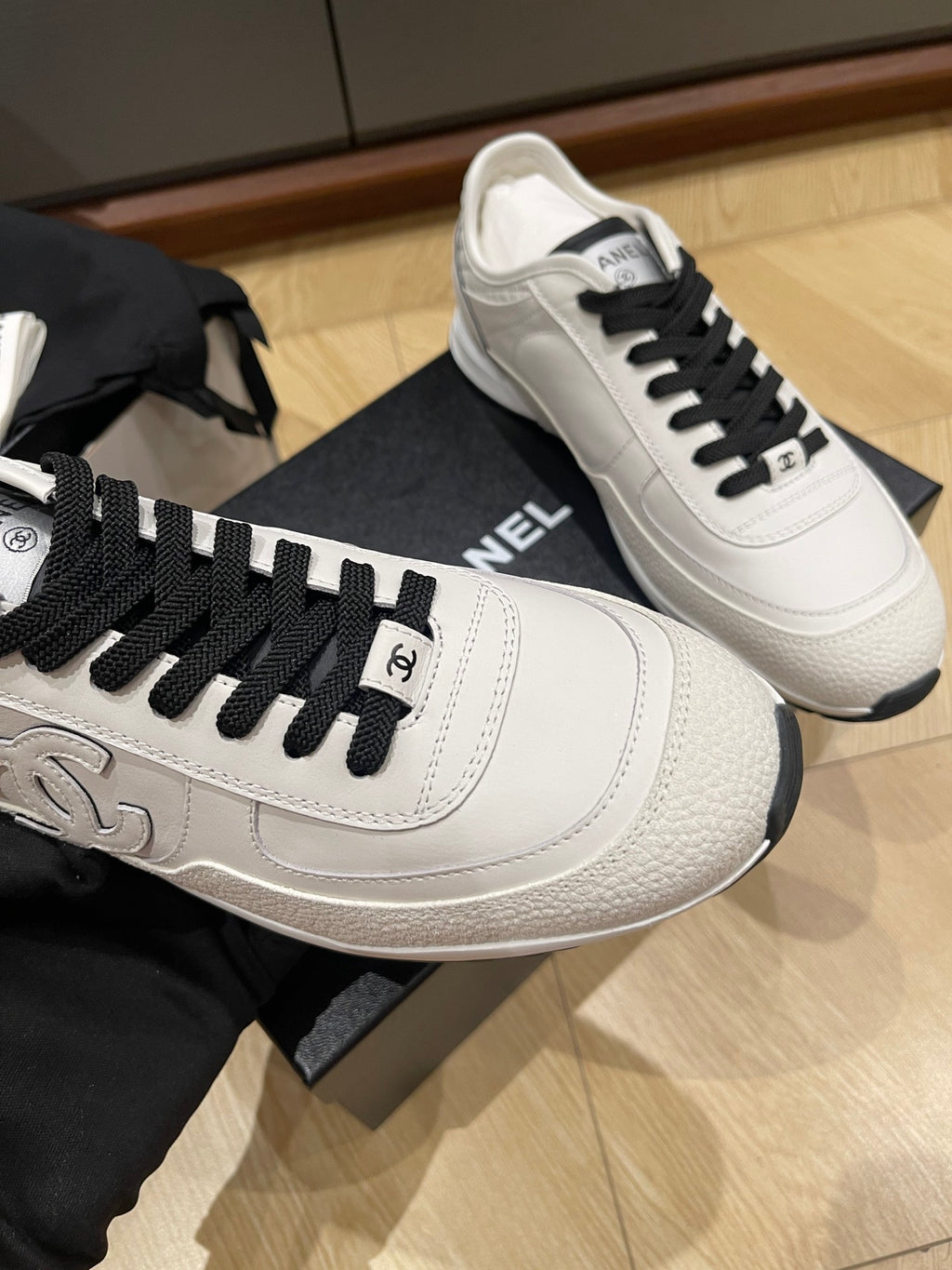 Chanel unisex low-top sneakers, white leather with black laces and heel branding