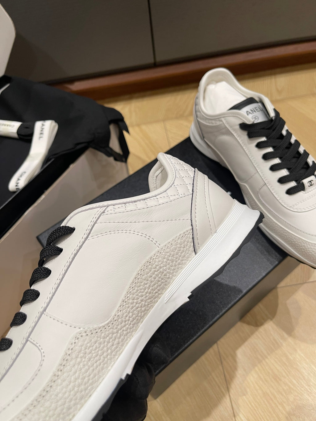 Chanel low-top sneakers, white leather with side strap detail and black lace-up