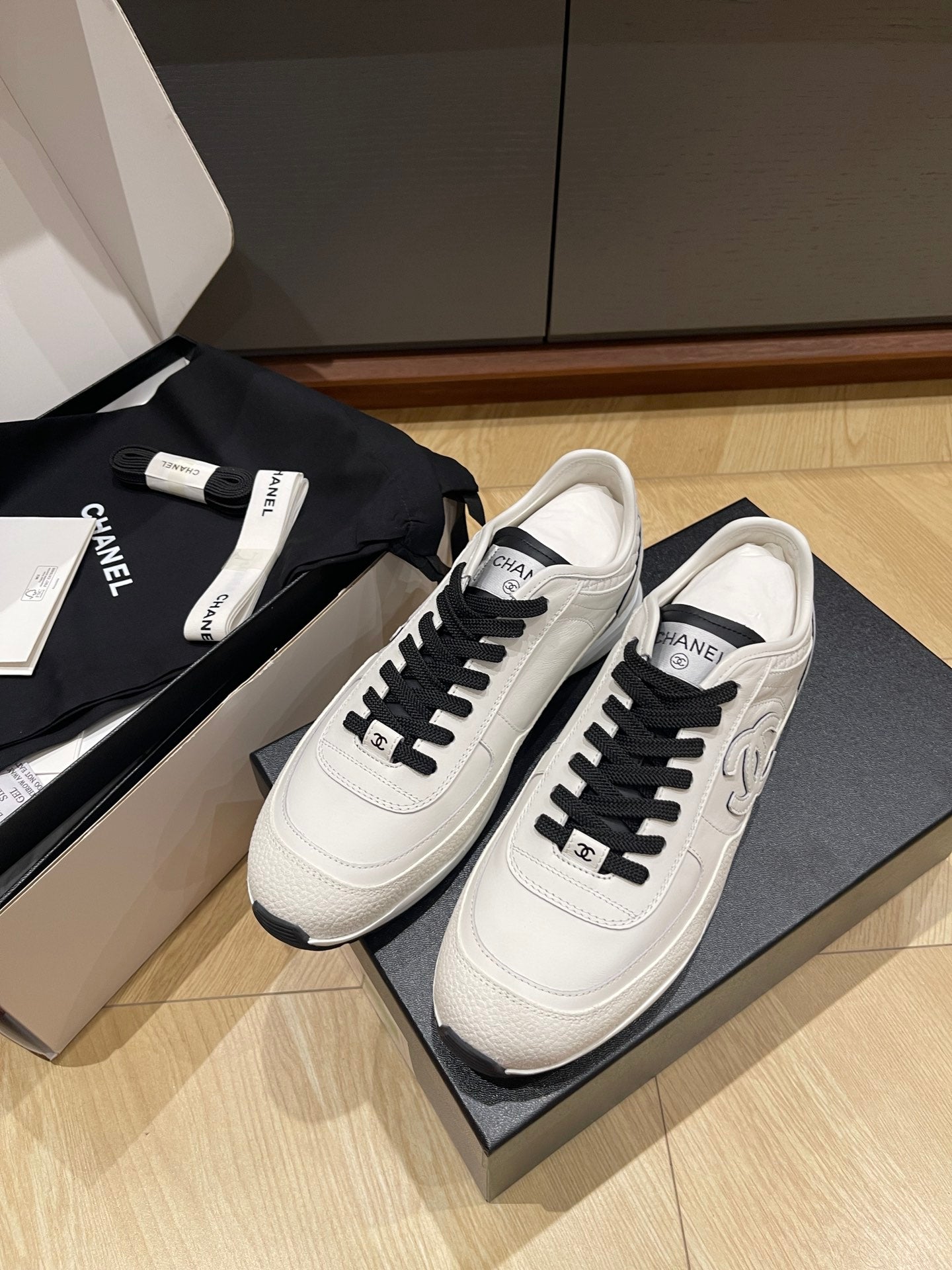 Chanel unisex low-top sneakers, white leather with black laces and rubber sole