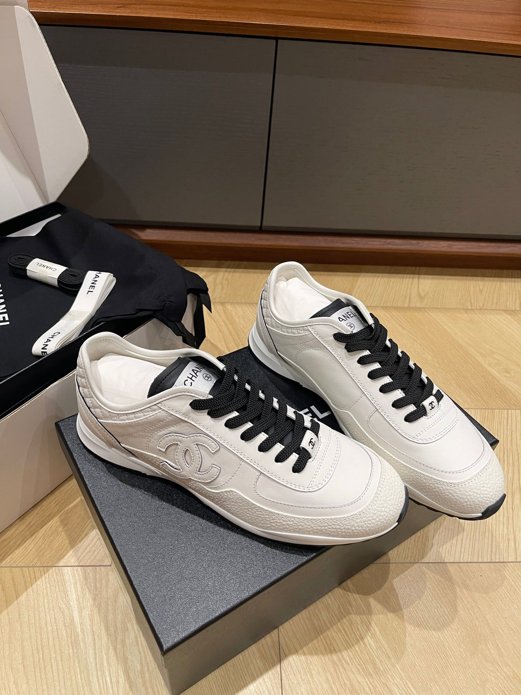 Chanel unisex low-top sneakers, white leather with black lace-up and side logo