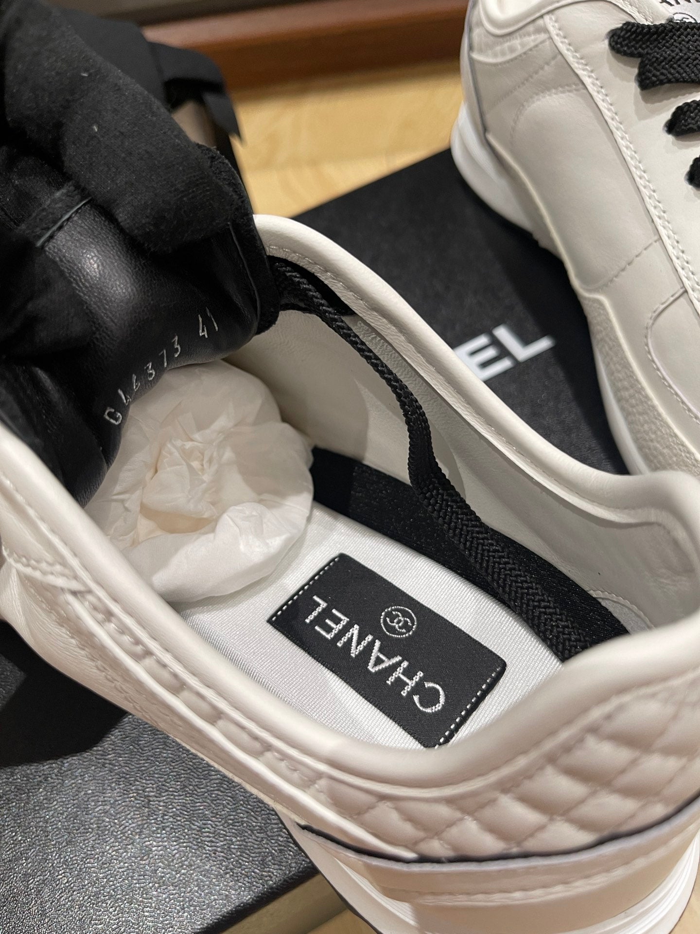 Chanel low-top sneakers, insole view with white lining and branded tongue label