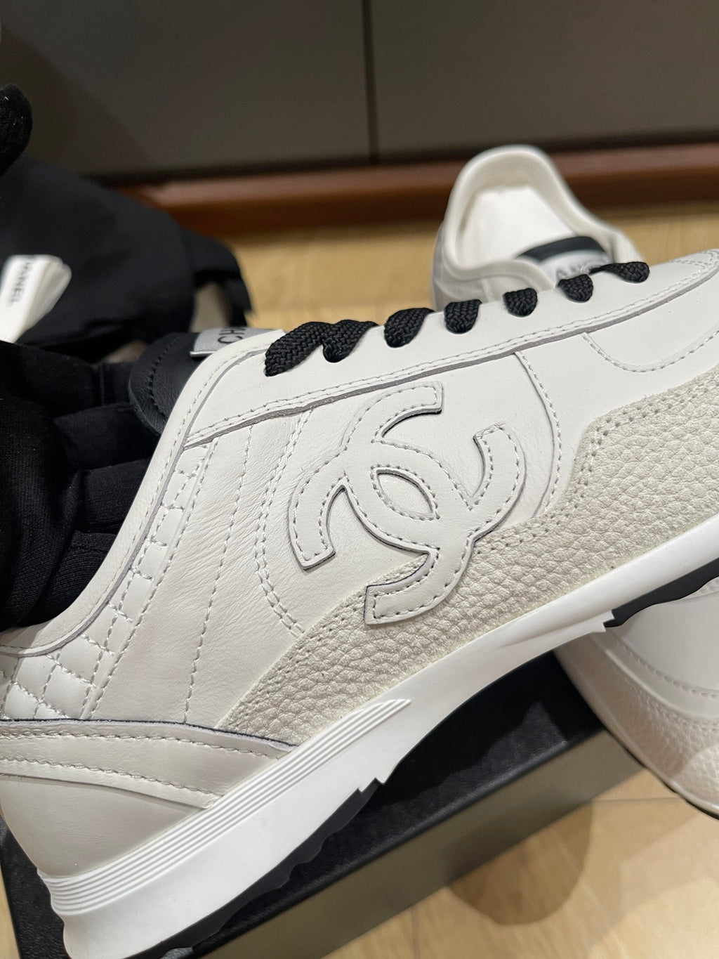 Chanel low-top sneakers, white leather with CC emblem panel and black lace-up