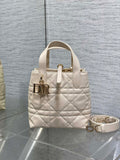 Dior cream quilted mini handbag with top handle and gold logo hardware, plus crossbody strap