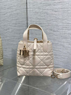 Dior cream quilted mini handbag with top handle and gold logo hardware, plus crossbody strap