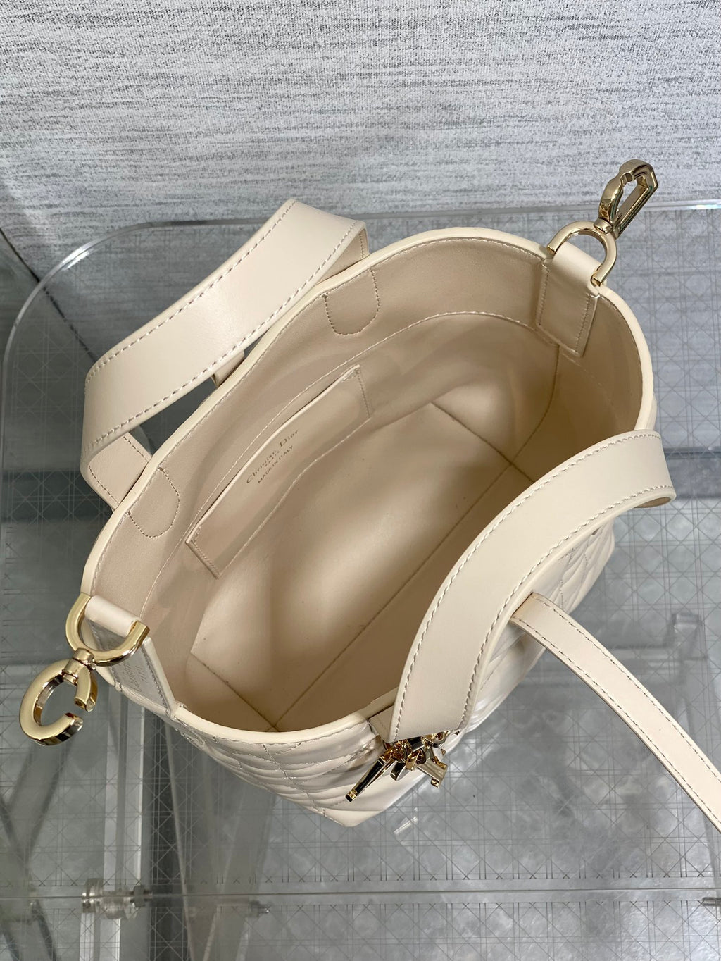 Dior cream quilted mini handbag open interior view with adjustable crossbody strap