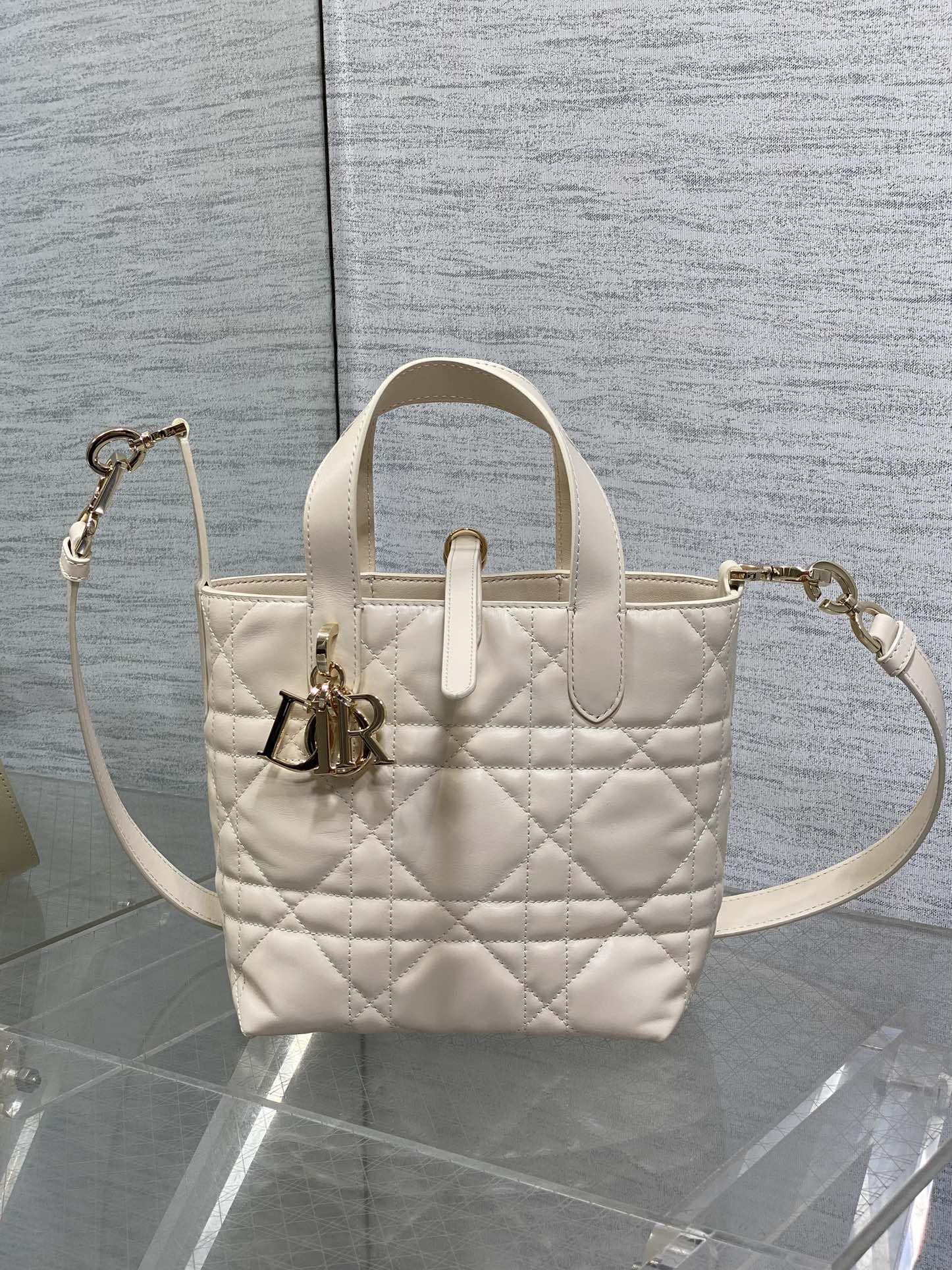Dior cream quilted mini handbag with top handle and adjustable shoulder strap, gold hardware