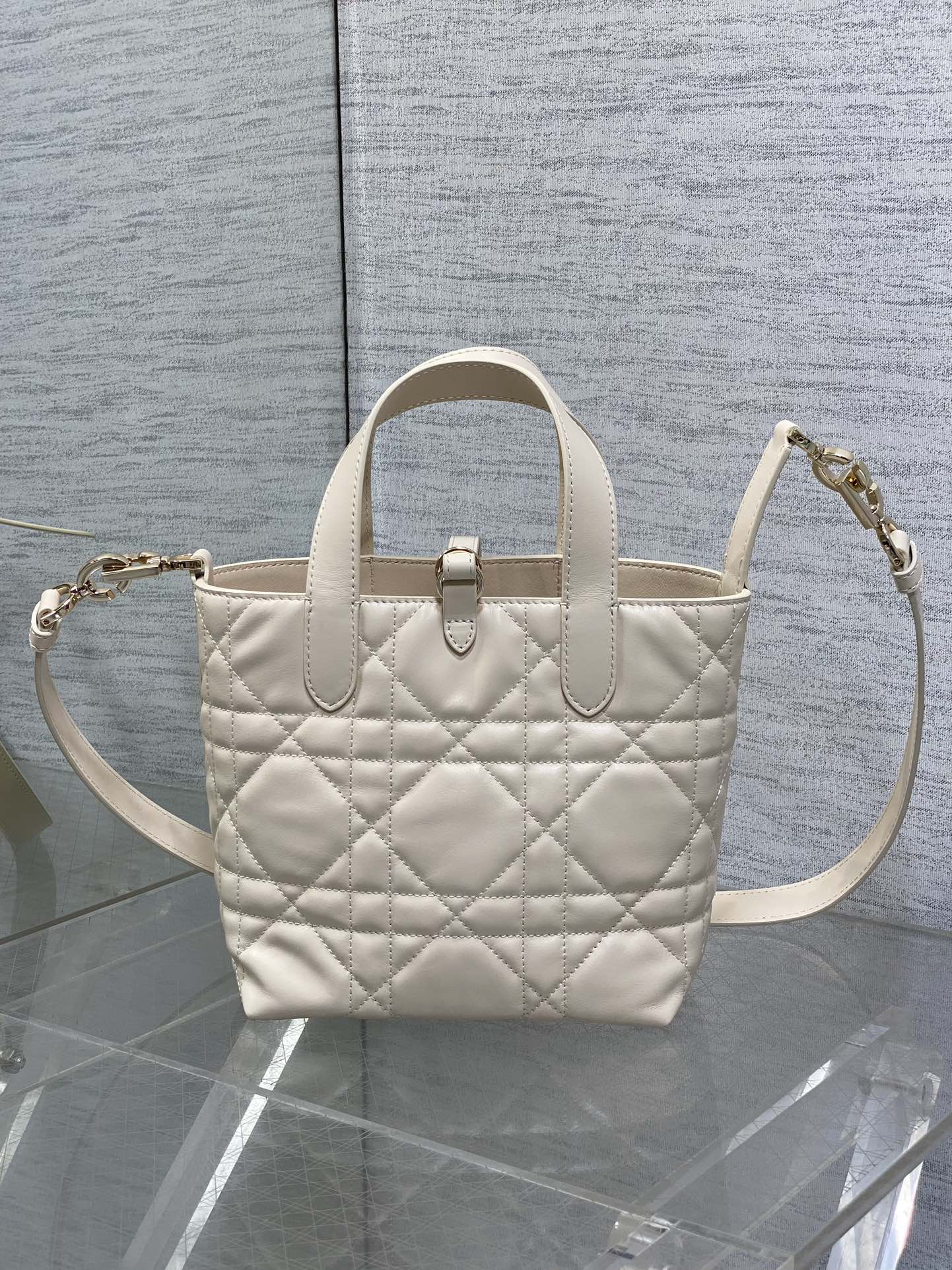 Dior cream quilted mini handbag with dual handles and crossbody strap, gold-tone accents